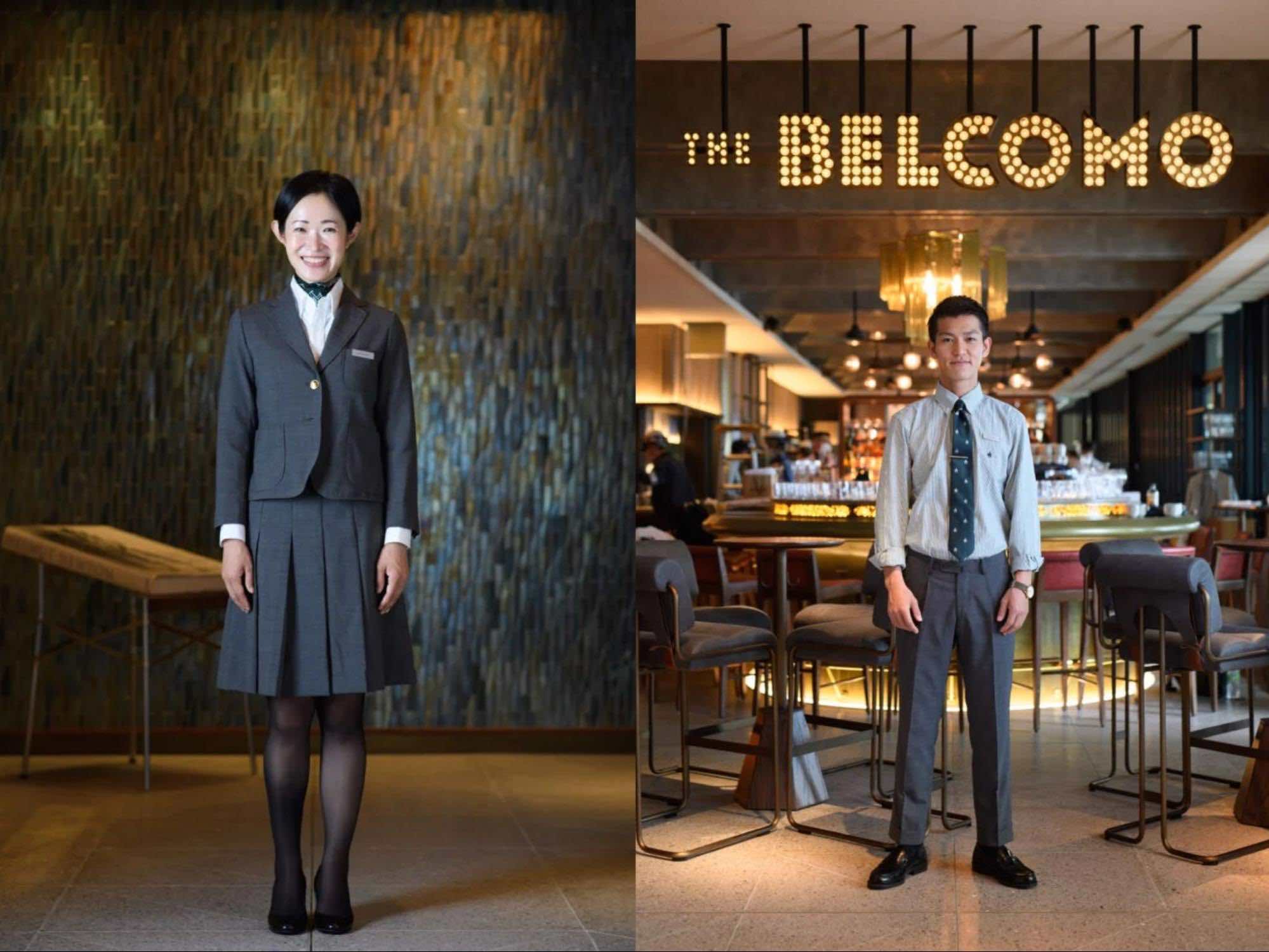 グレーのセットアップを着用した女性のスタッフと、グレーのネクタイ・パンツを着用した男性スタッフ